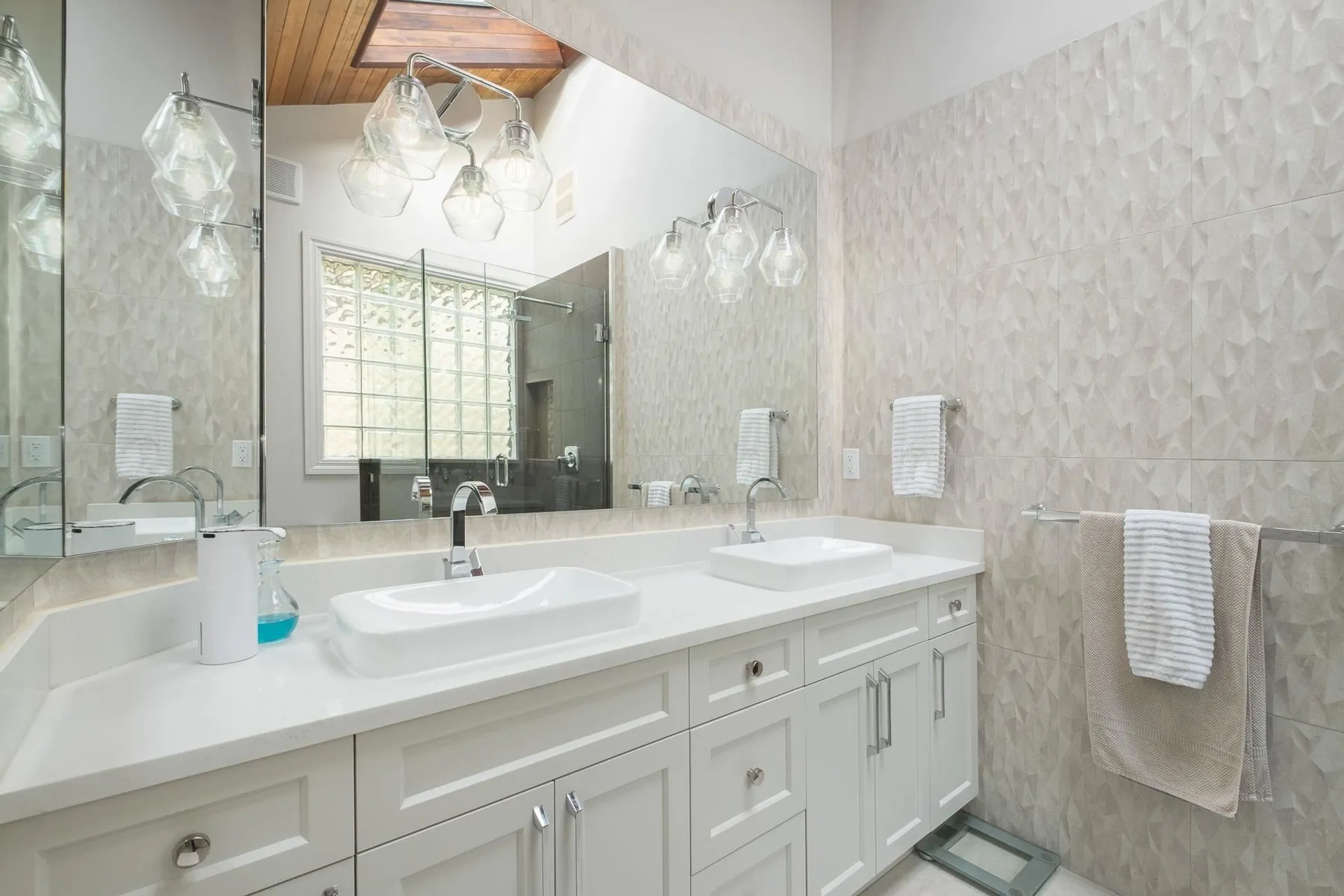 Bathroom with double sinks and modern fixtures after renovation